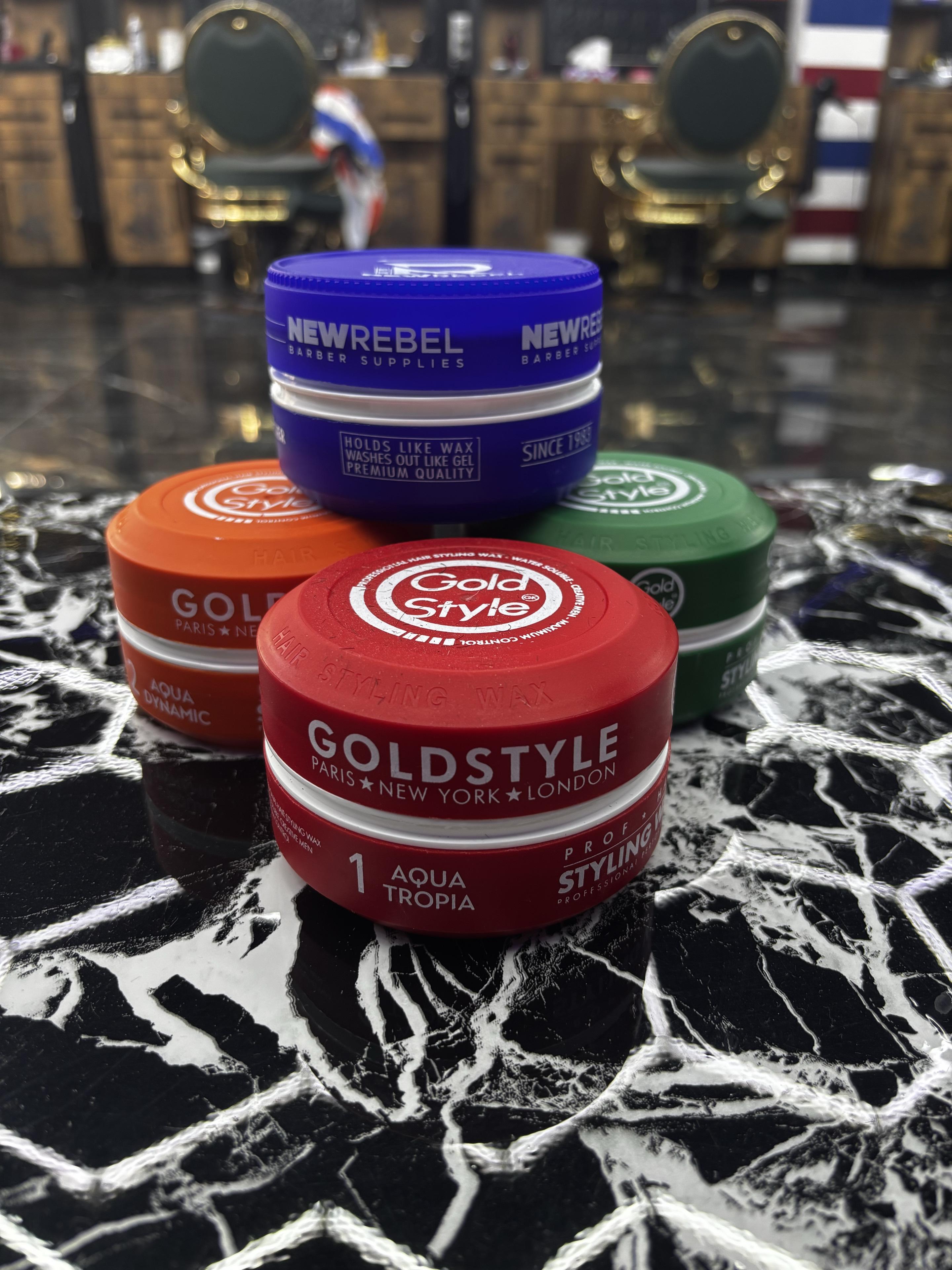 Stylingwachs von Gold Style und New Rebel auf einer Marmorfläche